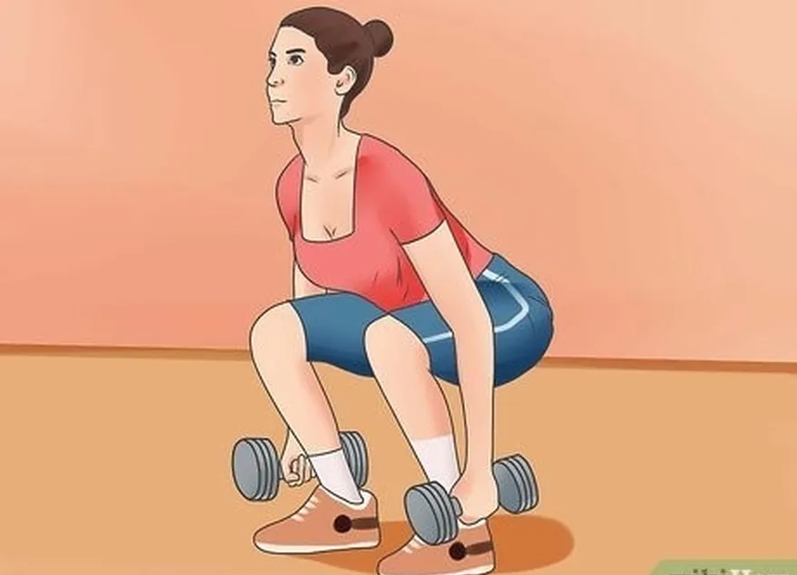 étape 1 : faites quelques flexions de jambes avec des haltères.