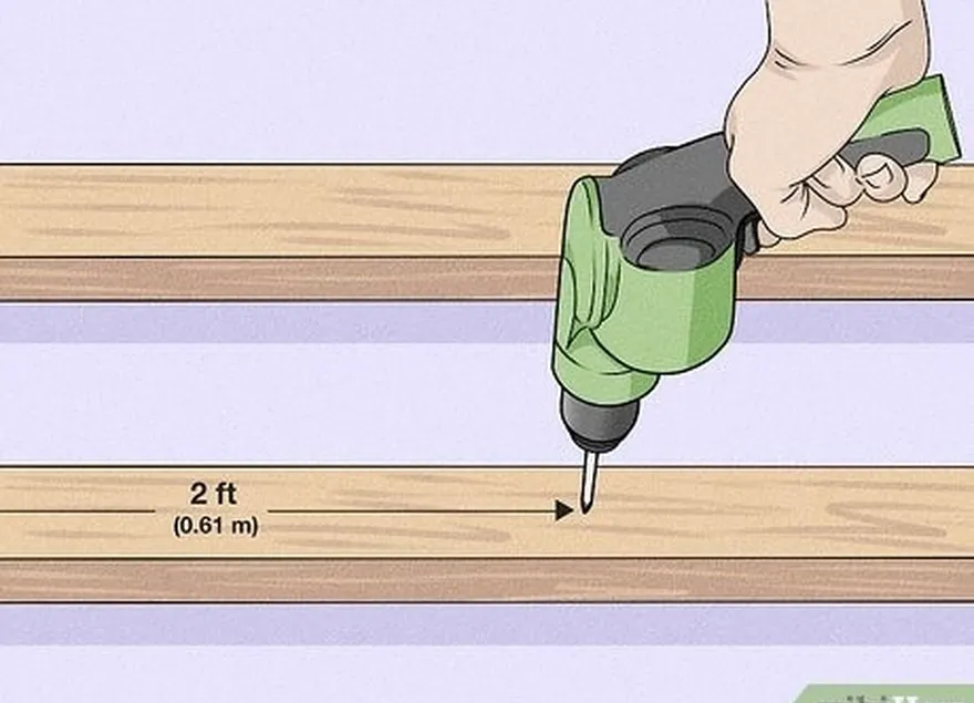 étape 3 percez un trou à 0,61 m du haut de chaque poutre en bois.