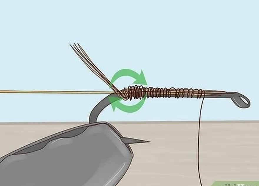 étape 4 enroulez les 2/3 de l'hameçon dans les fibres de la queue.